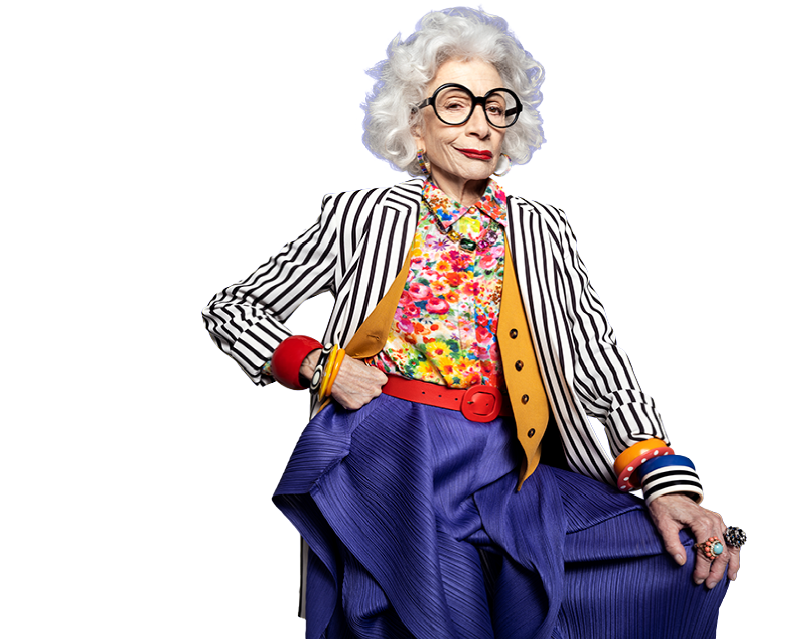 Potential KRAZATI® NSCLC patient wearing a colorful top and black and white striped jacket with a blue background.